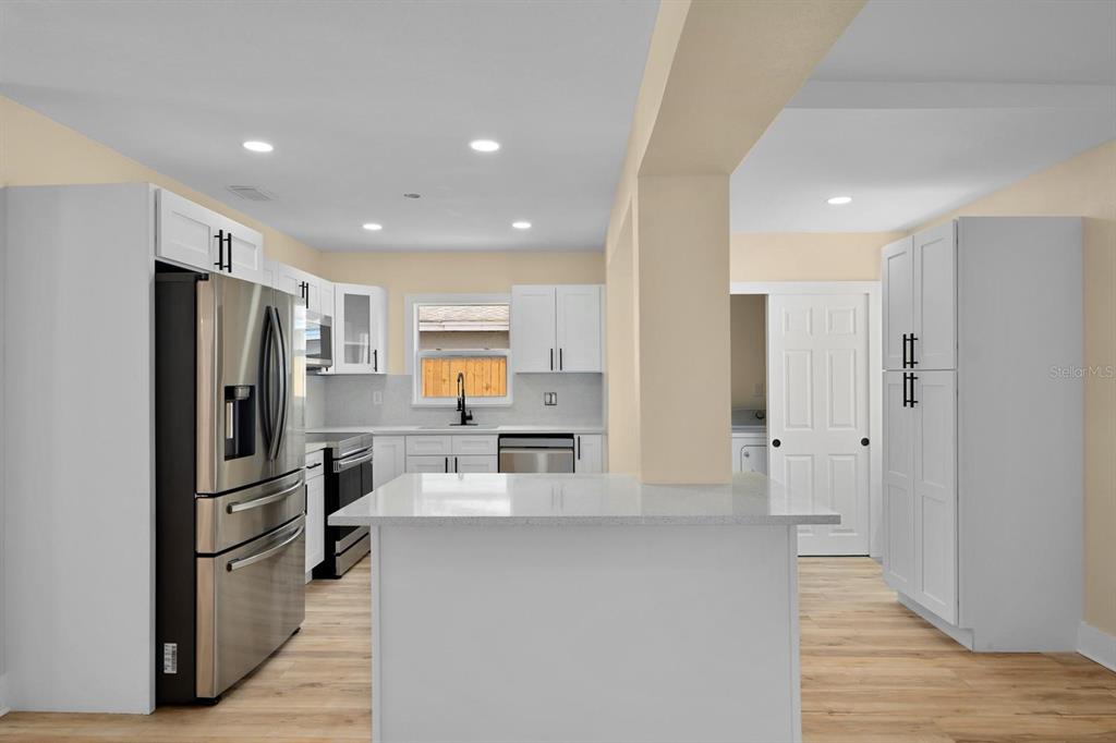 10707 North Rome Avenue Tampa, FL 33612 - Photo 26 of 35 a kitchen with stainless steel appliances a refrigerator and a stove top oven