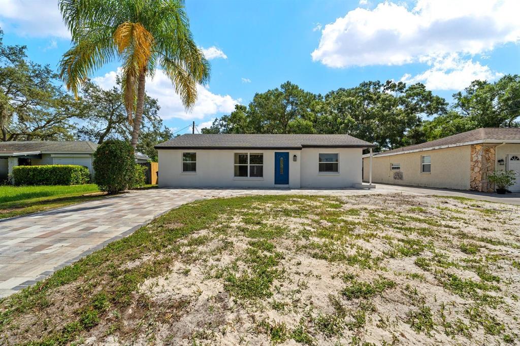 10707 North Rome Avenue Tampa, FL 33612 - Photo 3 of 35 a house with trees in front of it