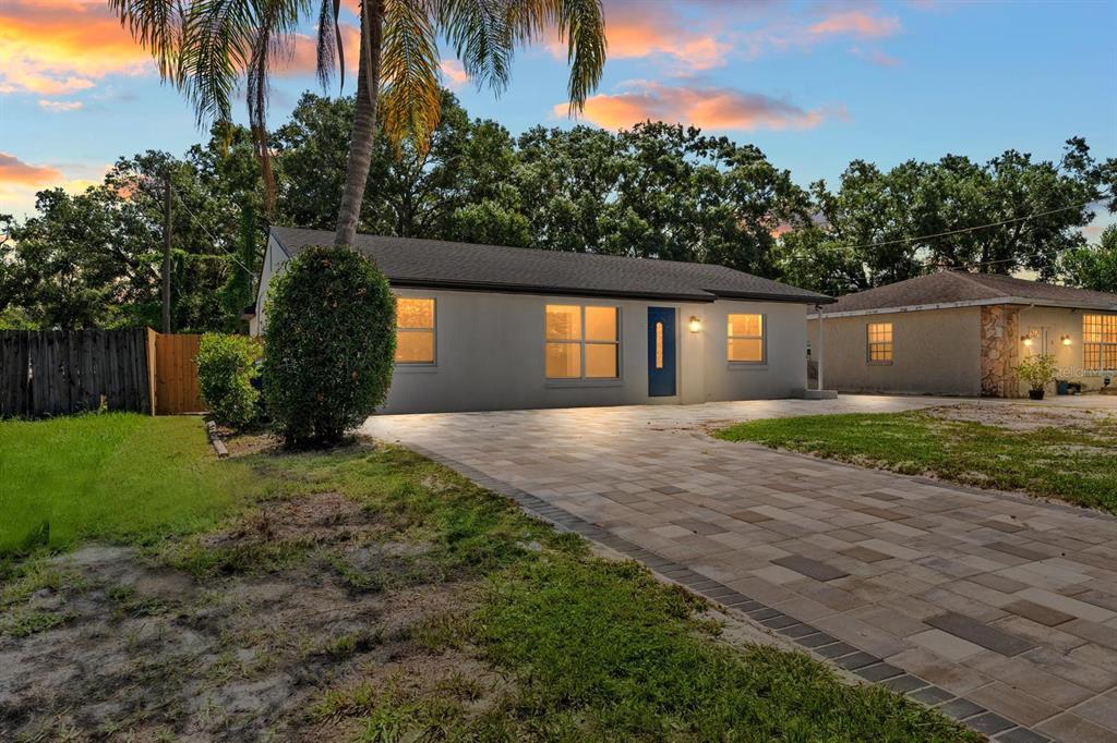 10707 North Rome Avenue Tampa, FL 33612 - Photo 5 of 35 a front view of a house with a yard and potted plants