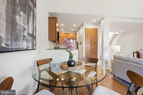 a dining room with furniture and wooden floor