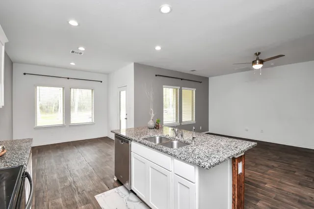 a bathroom with sink granite and a mirror