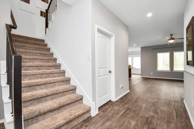 a view of an entryway with wooden floor and stairs