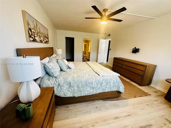 a bedroom with a bed and dresser