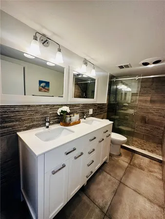 a bathroom with a sink double vanity and a mirror