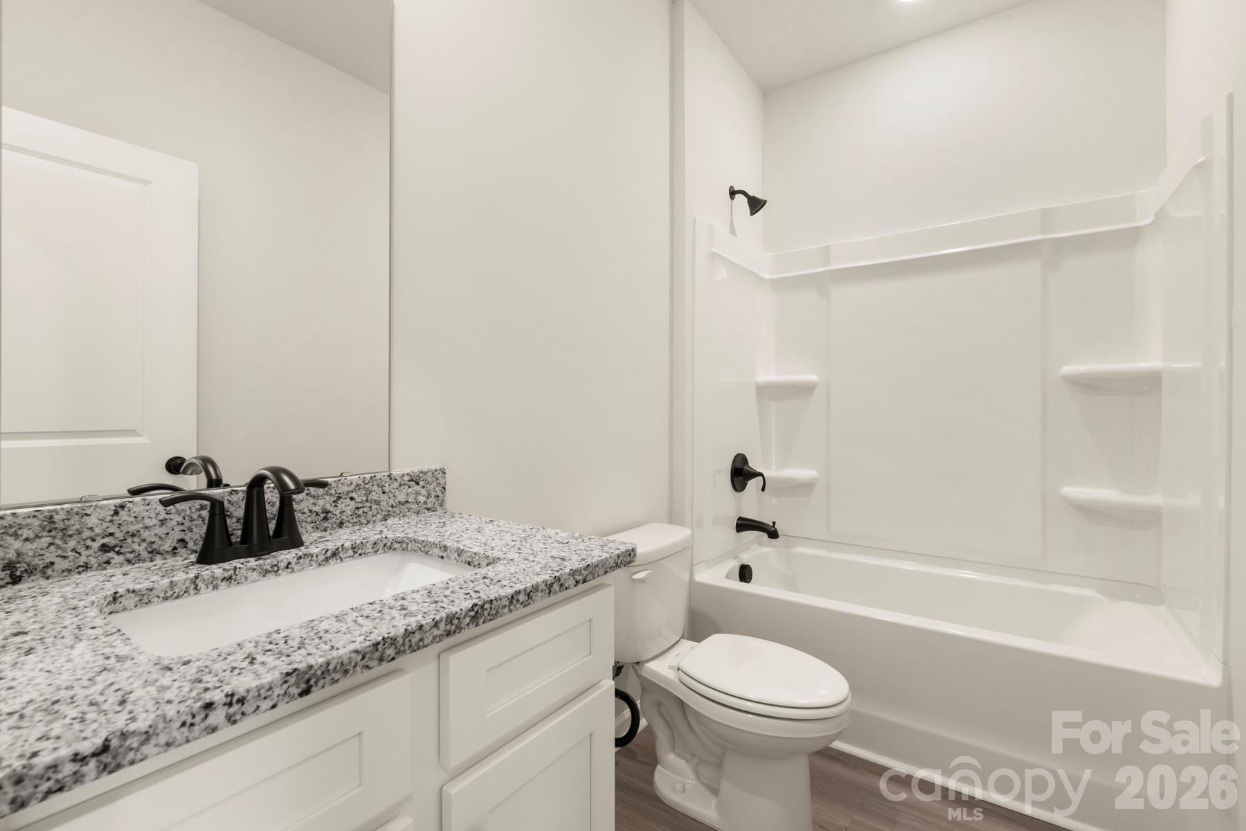 275 Limestone Terrace Salisbury, NC 28146 - Photo 22 of 22 a bathroom with a granite countertop sink a toilet and a bathtub