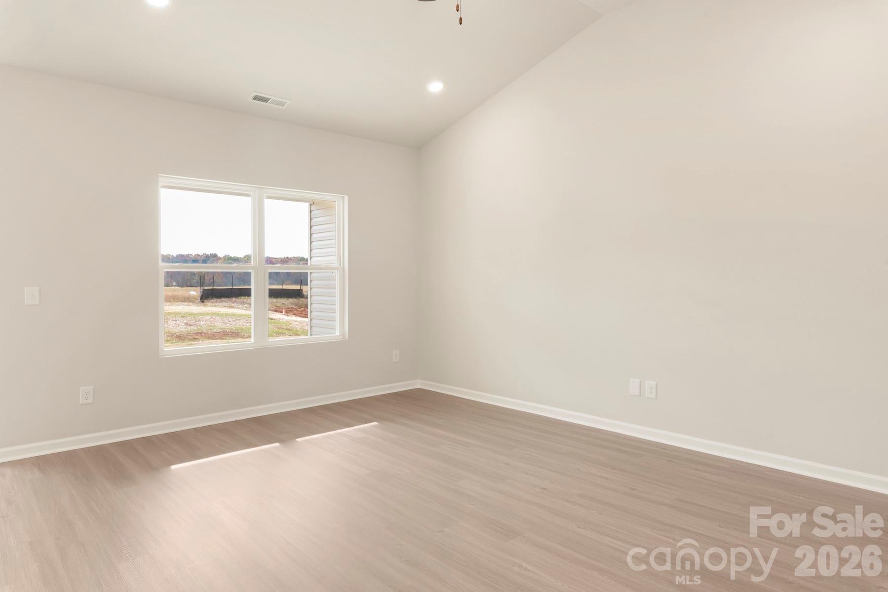 275 Limestone Terrace Salisbury, NC 28146 - Photo 9 of 22 an empty room with wooden floor and windows