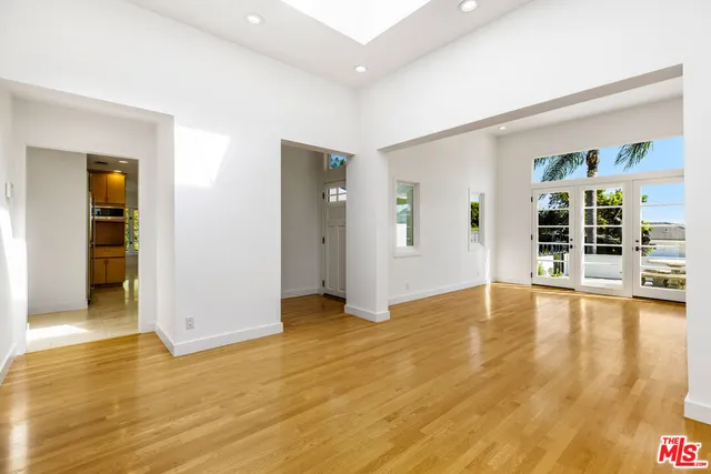 a view of empty room with wooden floor and fireplace
