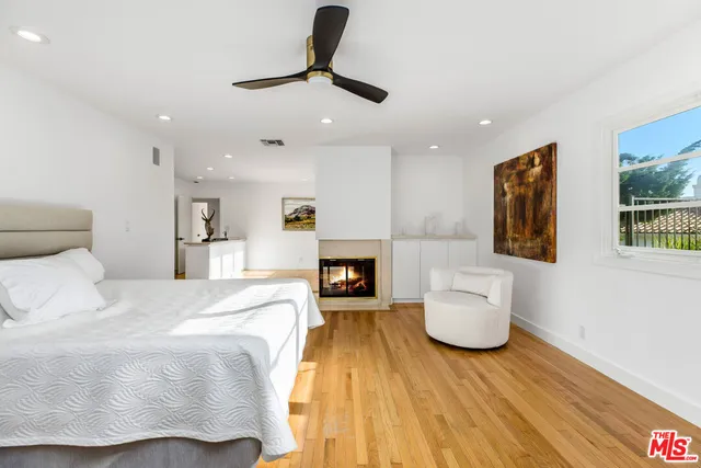 a spacious bedroom with a bed and a fireplace