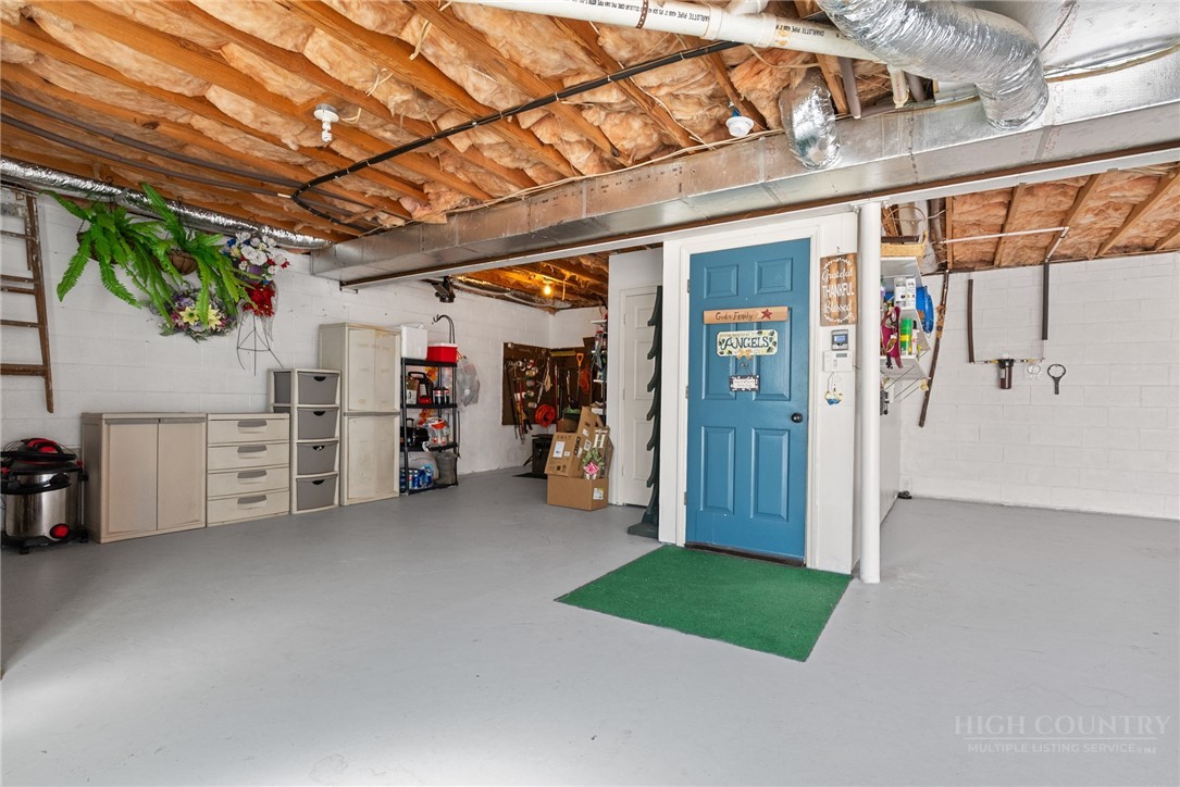 271 Quail Hollow Road Crumpler, NC 28617 - Photo 30 of 30 a view of a storage room with a garage