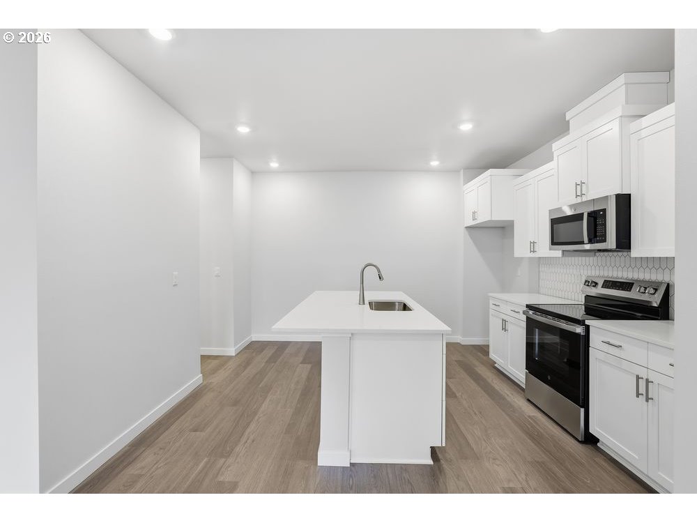 444 Southwest 32nd Street Battle Ground, WA 98604 - Photo 2 of 13 a kitchen with cabinets and steel appliances