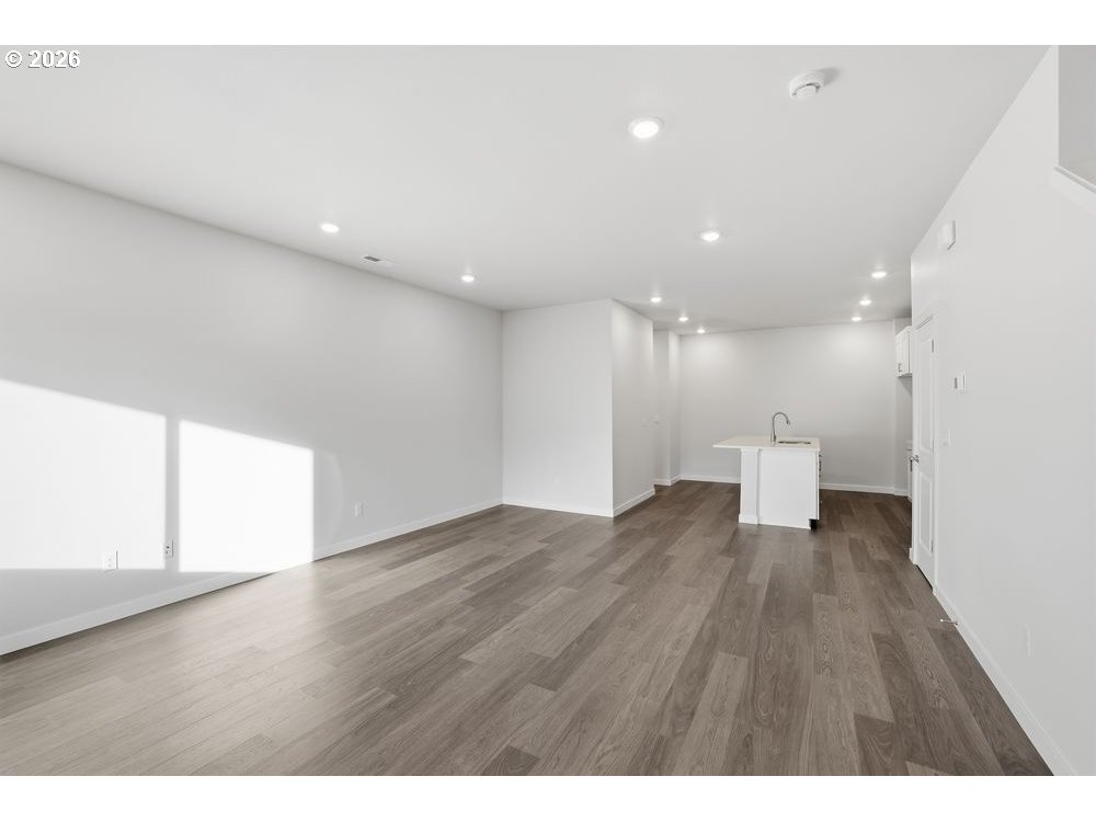 444 Southwest 32nd Street Battle Ground, WA 98604 - Photo 5 of 13 a view of an empty room with wooden floor and a window