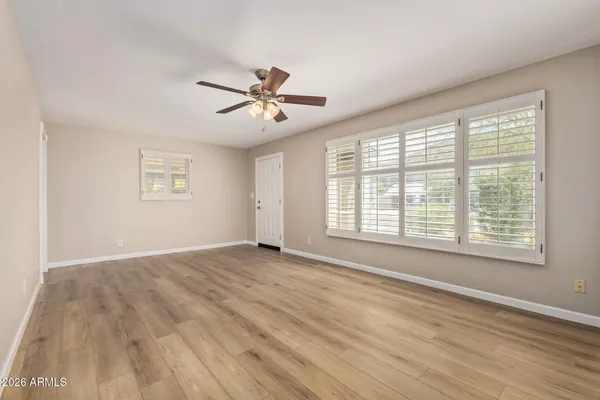 a view of an empty room with wooden floor