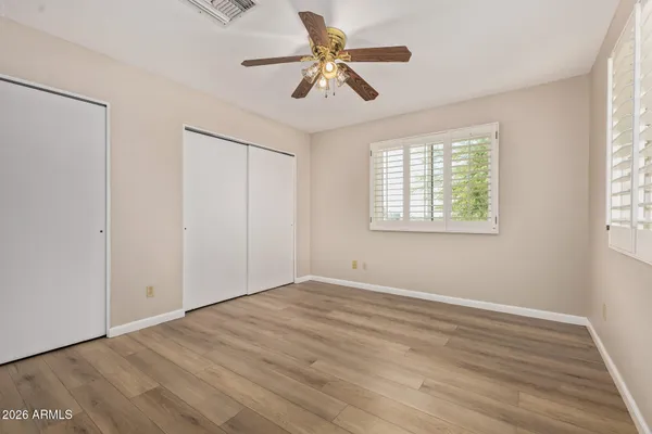 a view of an empty room and wooden floor