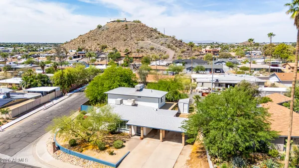 a view of a house with a yard and sitting area
