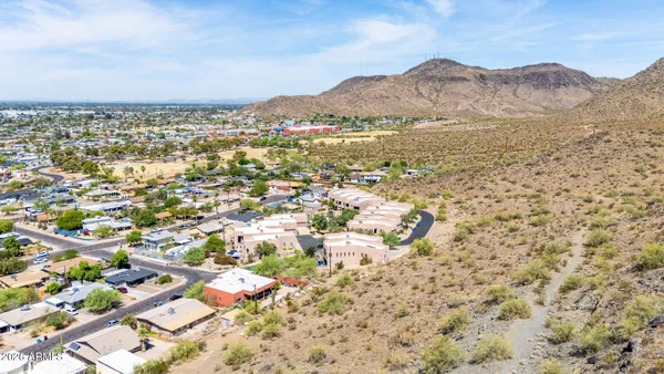 a kitchen with granite countertop stainless steel appliances a sink stove refrigerator and cabinets