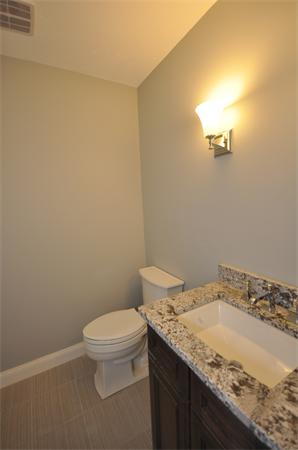 1136 Hill Road, Unit A Boxborough, MA 01719 - Photo 10 of 16 a bathroom with a granite countertop toilet and a sink