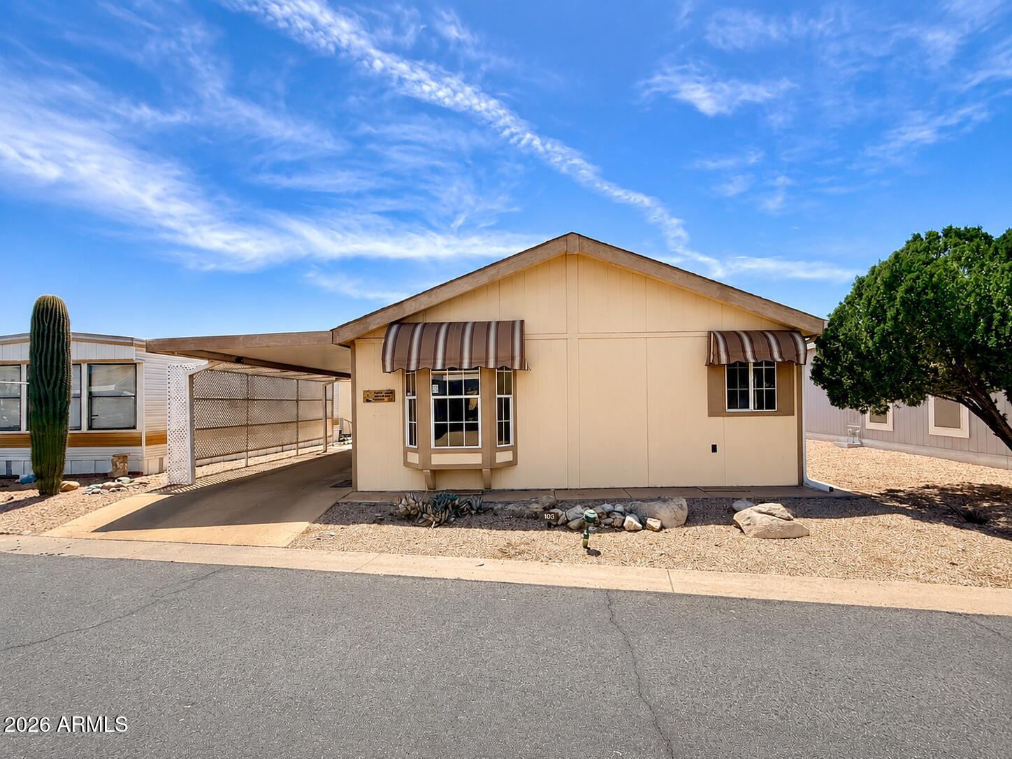 8865 East Baseline Road, Unit 103 Mesa, AZ 85209 - Photo 1 of 47 a front view of a house with a yard