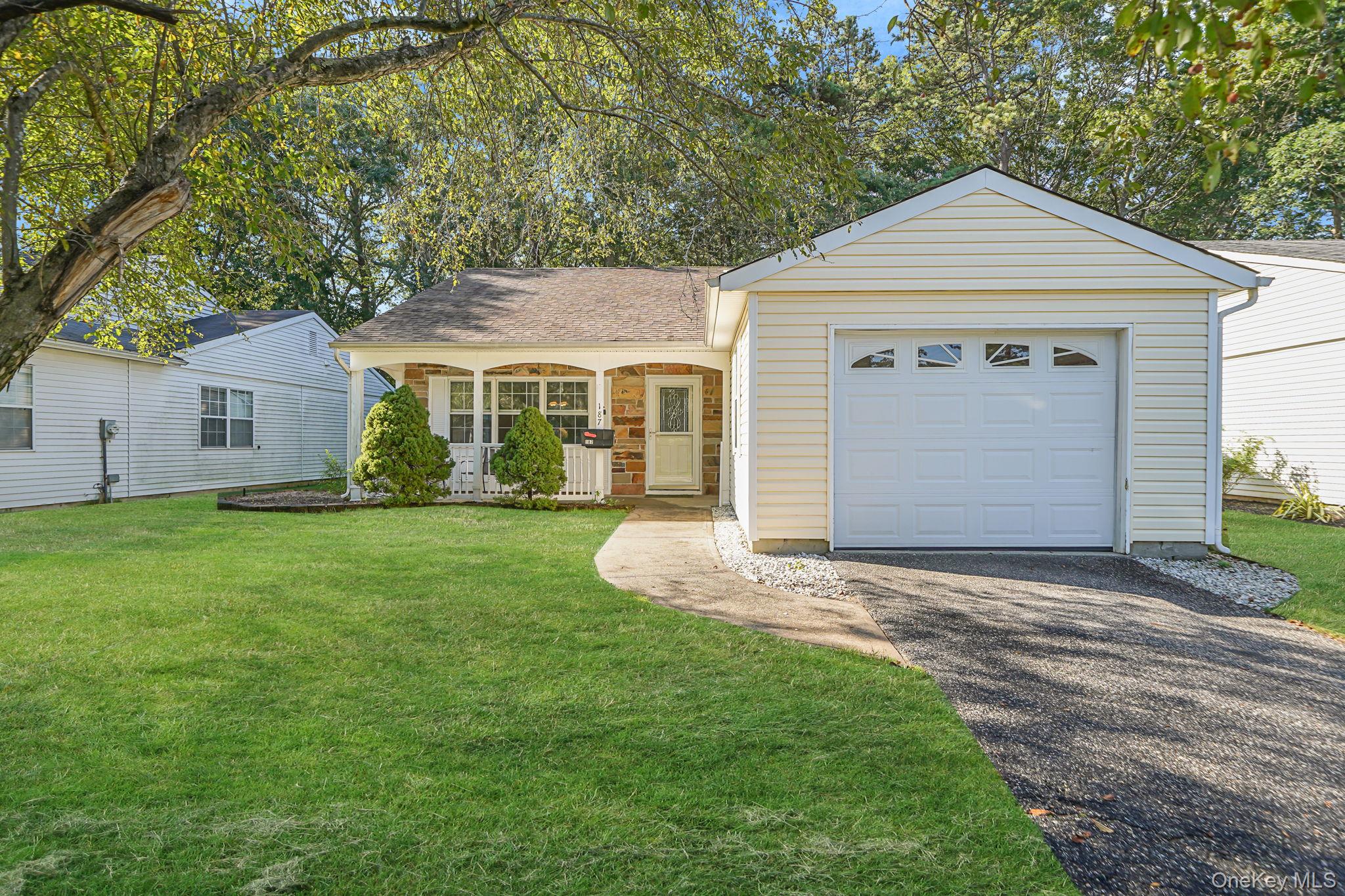 a front view of a house with a garden and yard