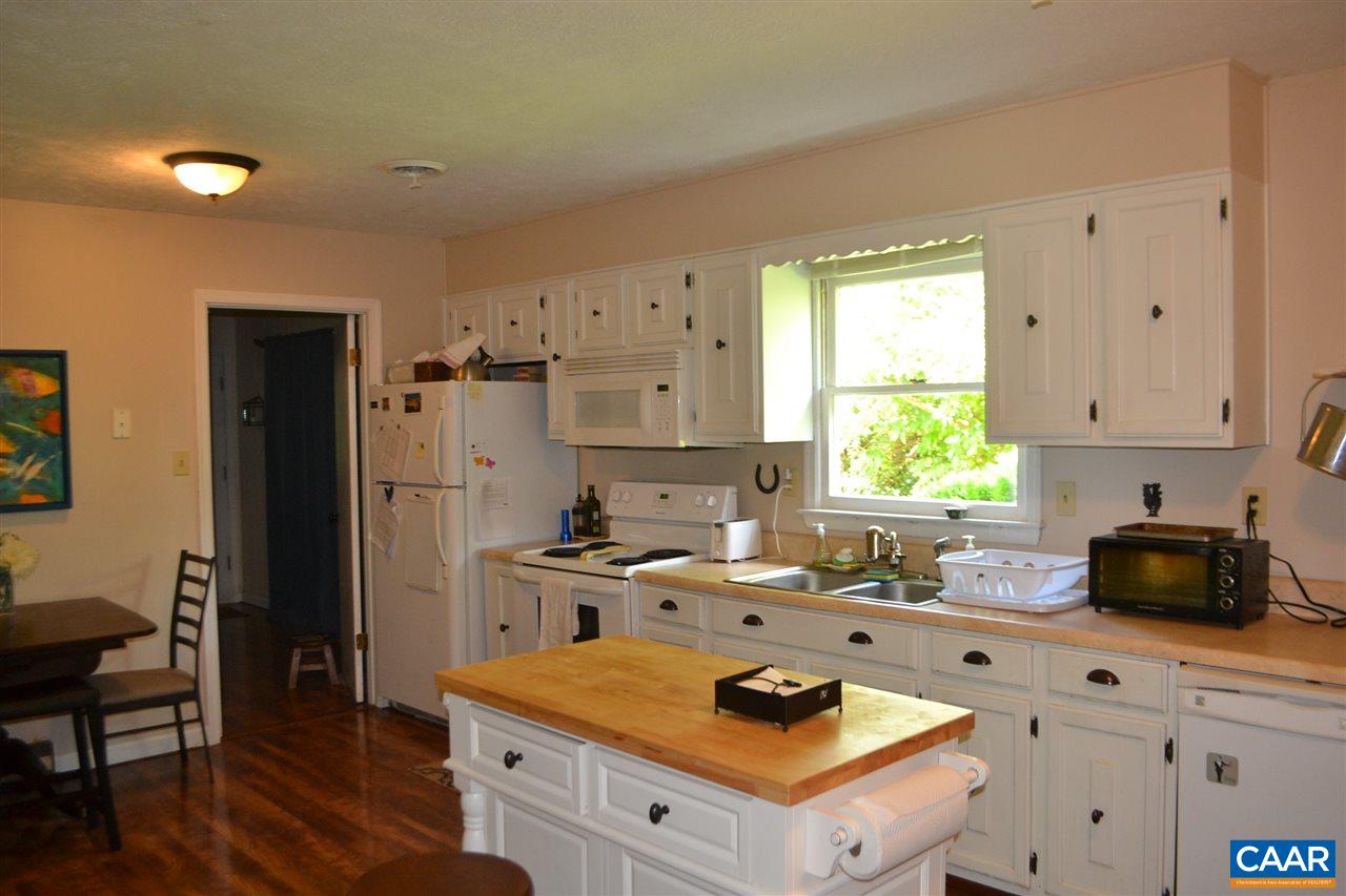 6239 Spring Hill Road Ruckersville, VA 22968 - Photo 14 of 25 a kitchen with granite countertop a stove a sink dishwasher and a refrigerator with wooden floor