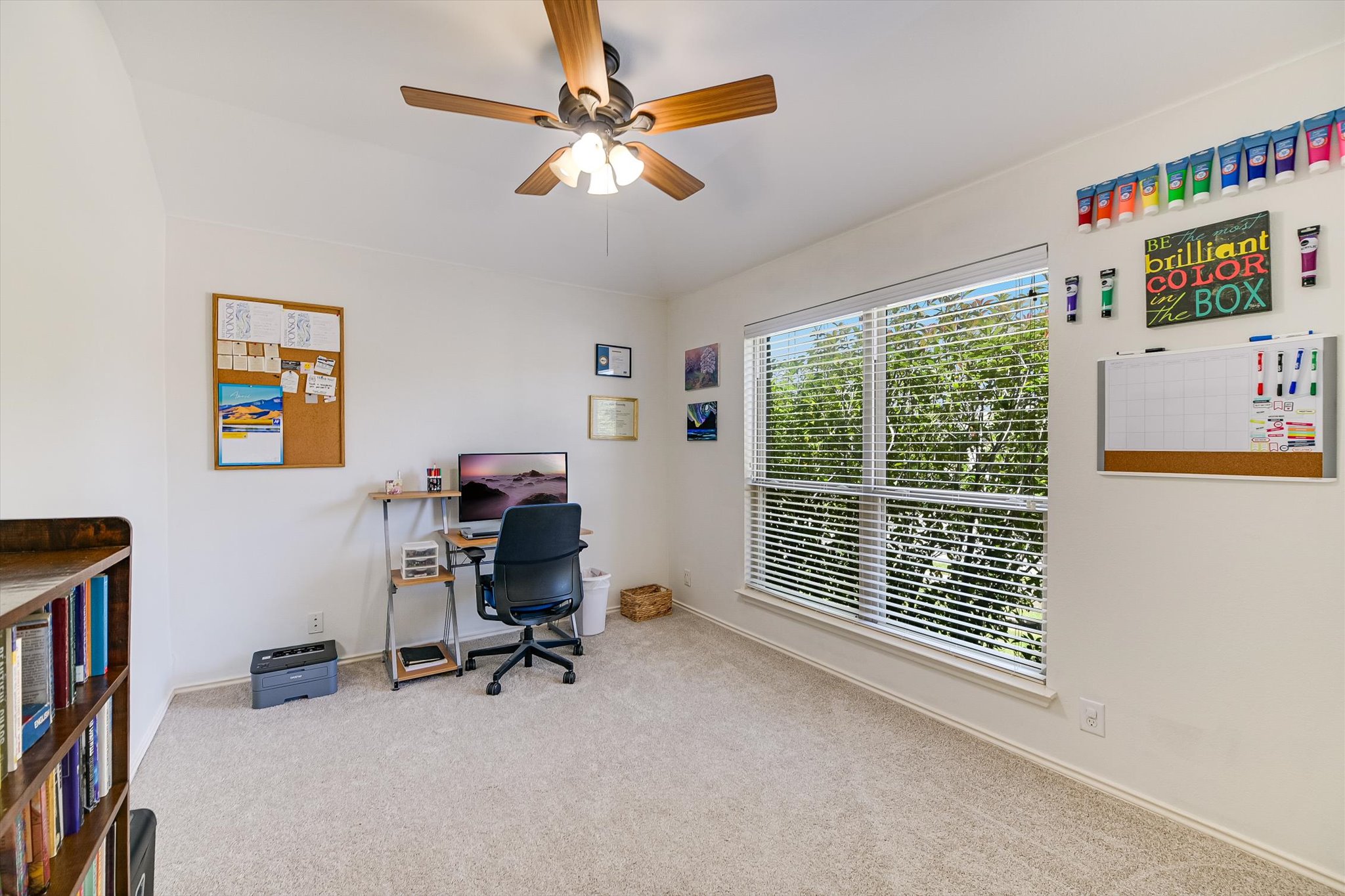 536 Dragon Ridge Road Buda, TX 78610 - Photo 15 of 20 Bright room with a large window, neutral carpeting, and a ceiling fan with integrated lighting
