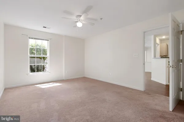 an empty room with windows and entrance