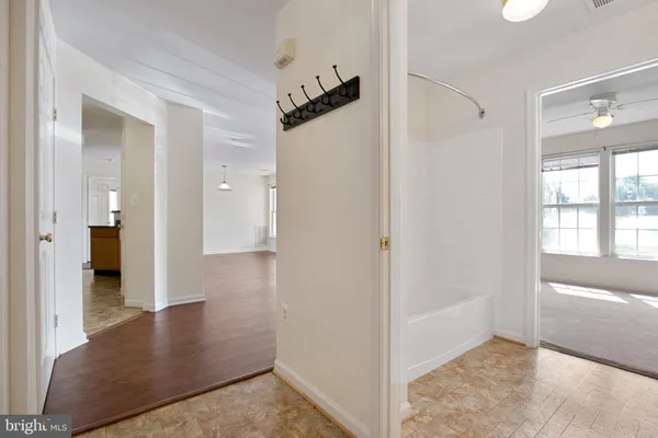 a view of a hallway view with wooden floor and staircase