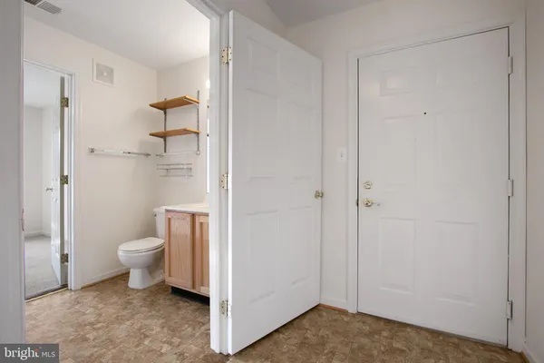 a bathroom with a granite countertop toilet and a shower