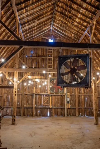 a view of yard with tree in front of it