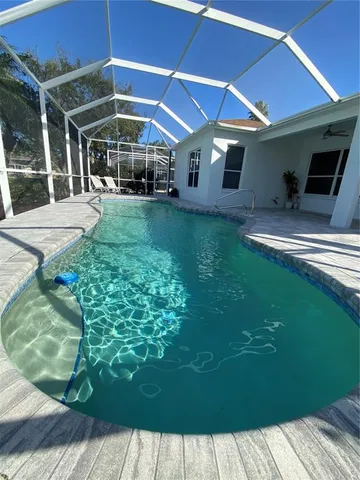 a view of a patio with table and chairs under an umbrella