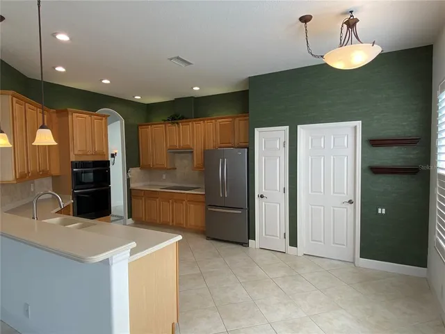 a kitchen with stainless steel appliances granite countertop a refrigerator and a sink