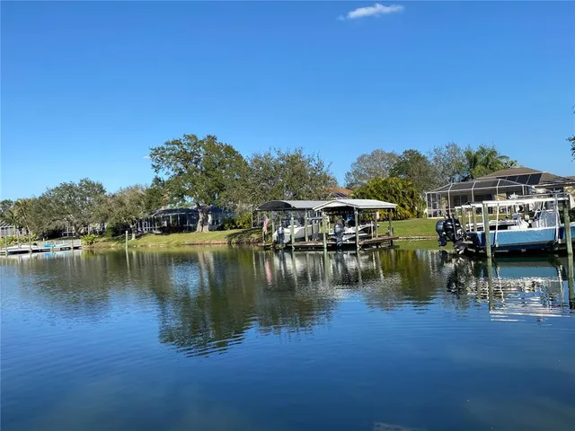 a view of residential house with outdoor space and lake view