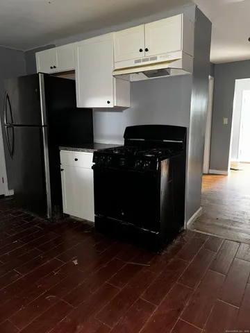 a kitchen with a refrigerator and a stove