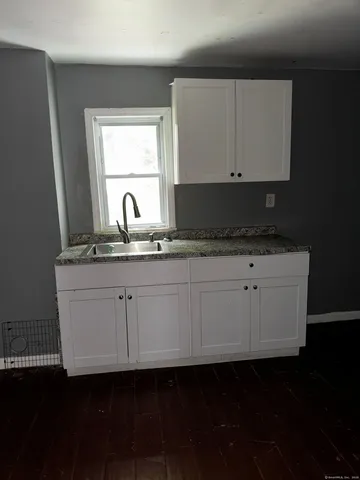 a kitchen with a sink and cabinets