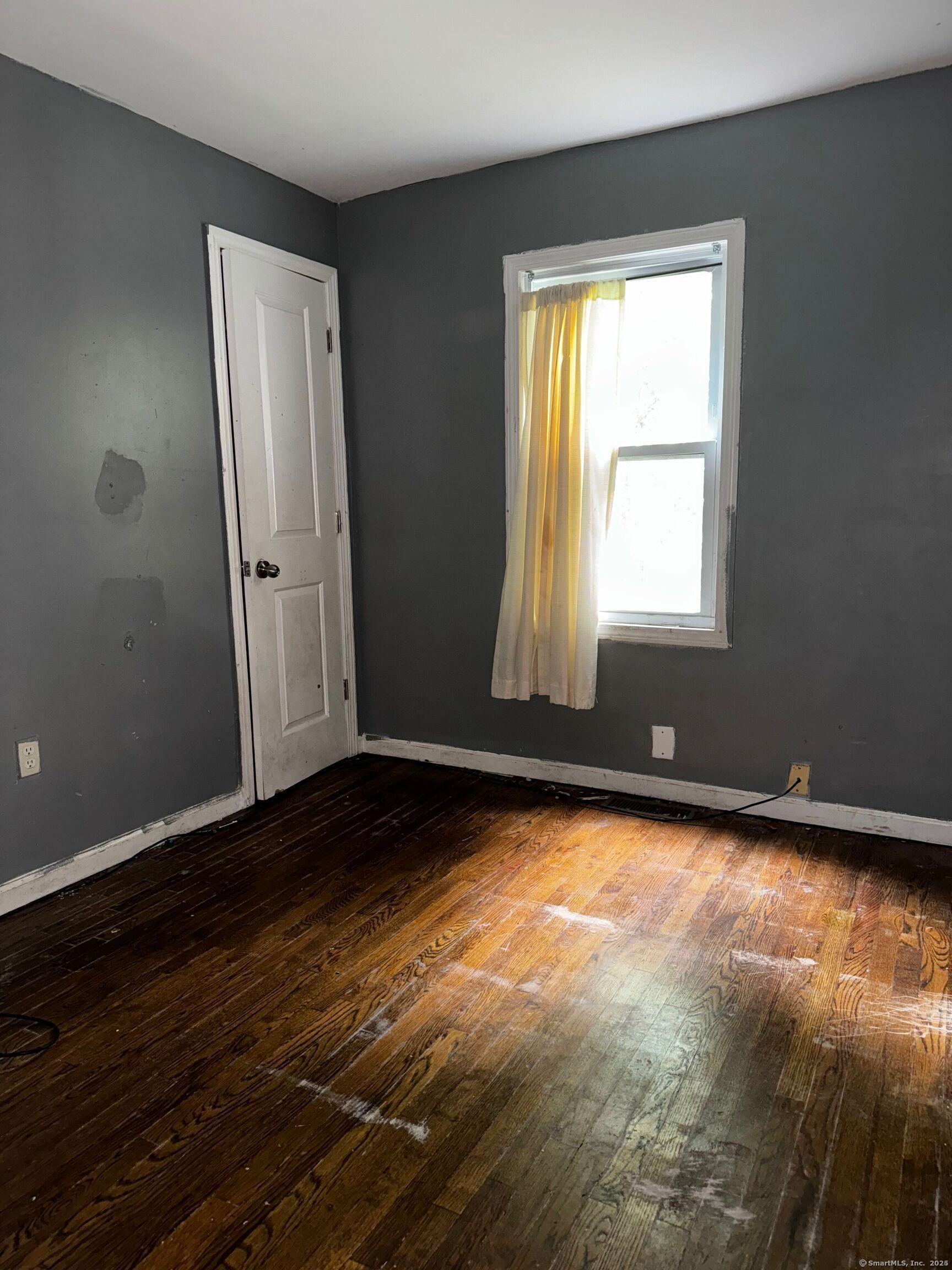 254 Starr Street New Haven, CT 06511 - Photo 7 of 8 a view of an empty room with wooden floor and a window