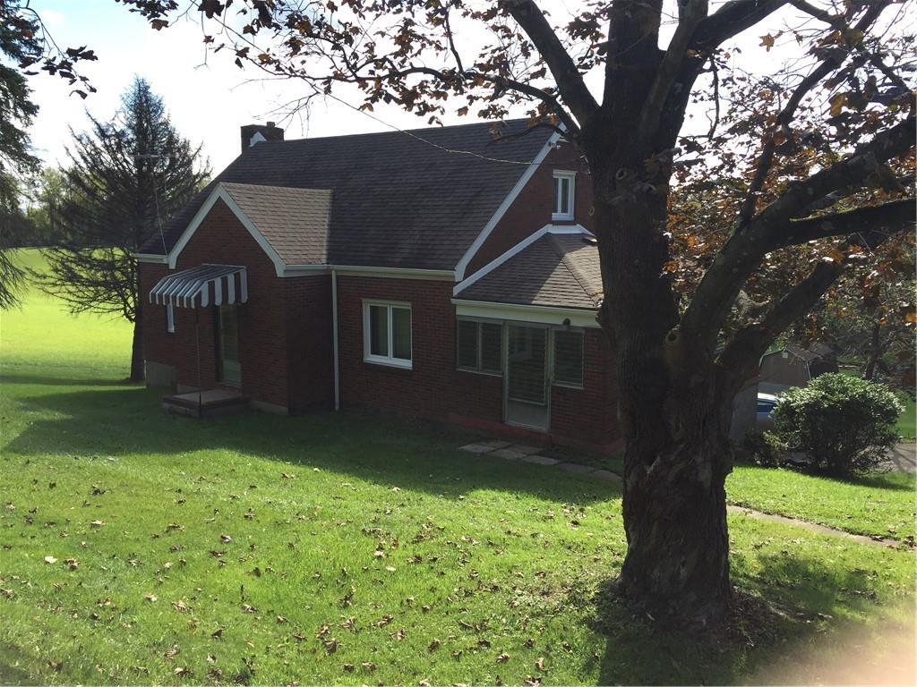 522 Middletown Road New Stanton, PA 15672 - Photo 1 of 22 a backyard of a house with lots of green space and garden