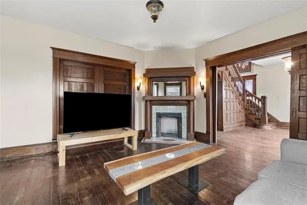a view of a livingroom with wooden floor and a window