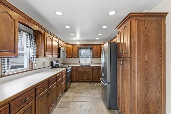 a large kitchen with kitchen island granite countertop a sink and dishwasher