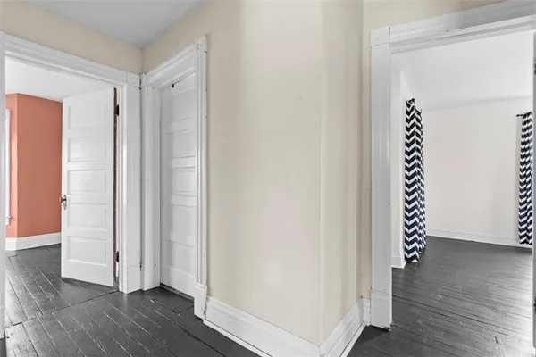 an empty room with wooden floor and window