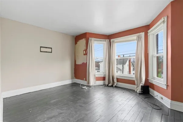 a view of a livingroom with furniture and an empty room