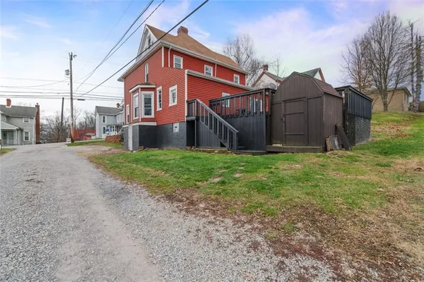 a view of a house with yard and sitting area