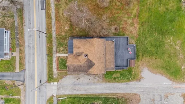 an aerial view of a house with a yard