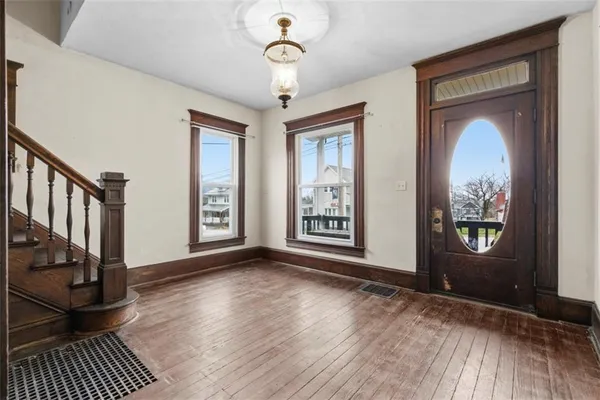a view of entryway and hall with wooden floor