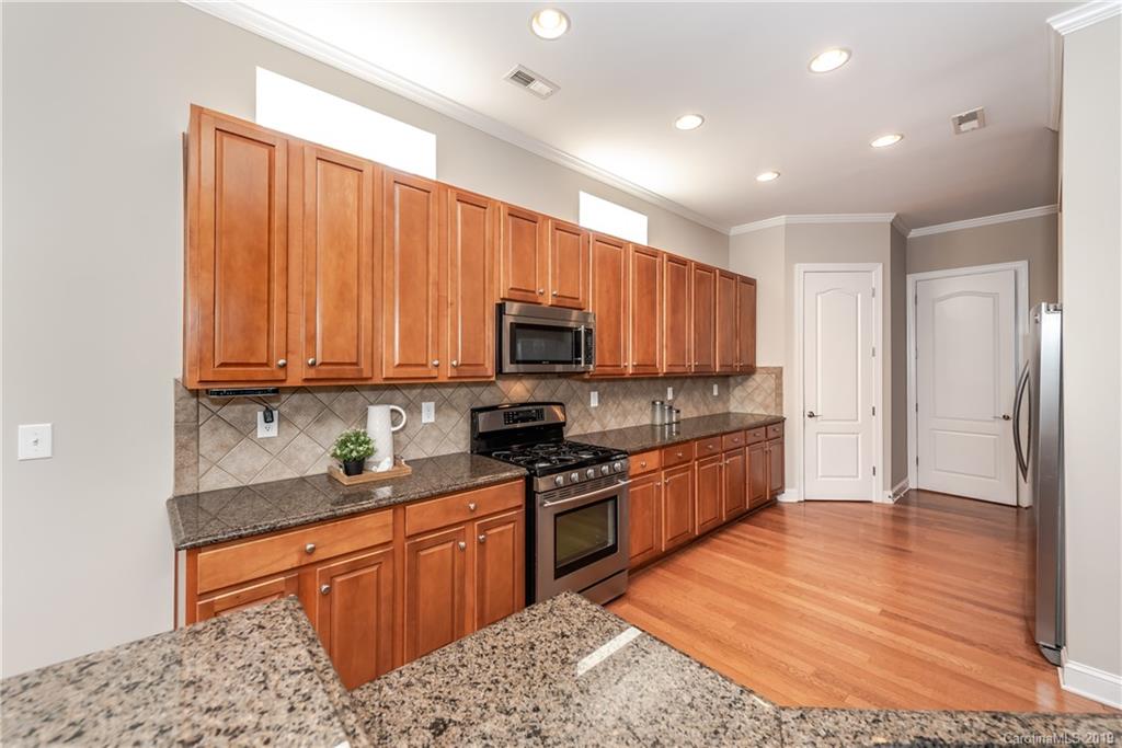 872 Treasure Court Fort Mill, SC 29708 - Photo 13 of 42 a large kitchen with stainless steel appliances granite countertop a stove a sink dishwasher and a refrigerator