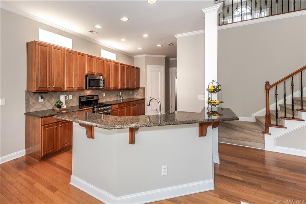 872 Treasure Court Fort Mill, SC 29708 - Photo 17 of 42 a kitchen with stainless steel appliances granite countertop a stove a sink a refrigerator and a microwave