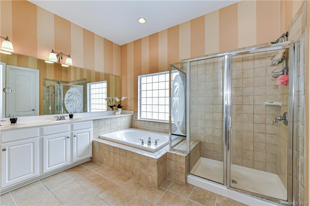872 Treasure Court Fort Mill, SC 29708 - Photo 20 of 42 a spacious bathroom with a shower a mirror and a bathtub