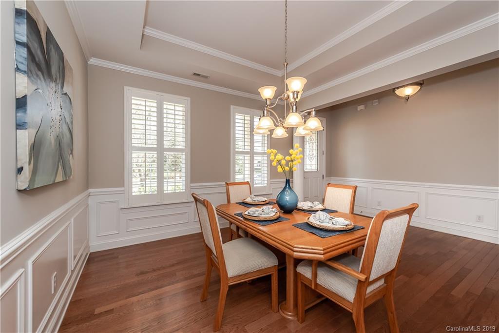 872 Treasure Court Fort Mill, SC 29708 - Photo 3 of 42 a dining room with furniture a chandelier and wooden floor