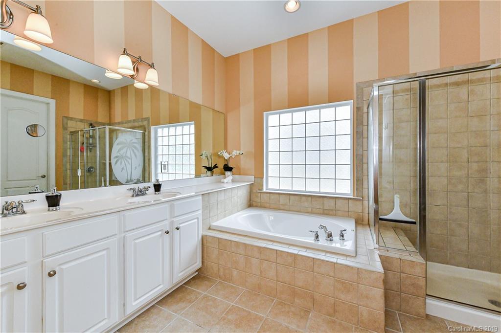 872 Treasure Court Fort Mill, SC 29708 - Photo 21 of 42 a bathroom with a tub sink and mirror