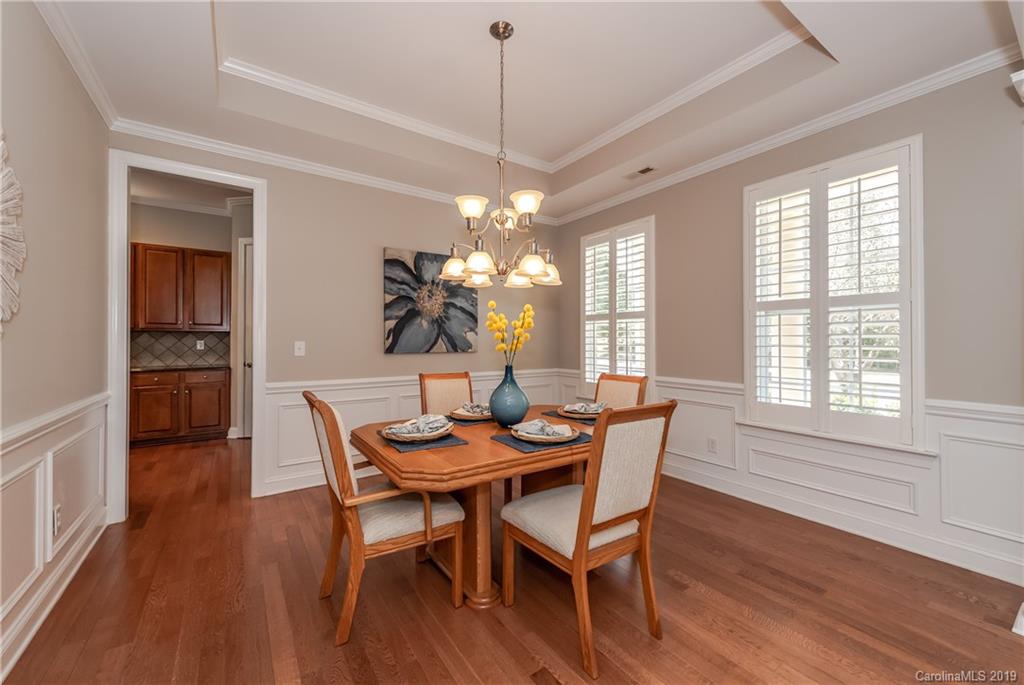 872 Treasure Court Fort Mill, SC 29708 - Photo 4 of 42 a dining room with furniture a chandelier and wooden floor