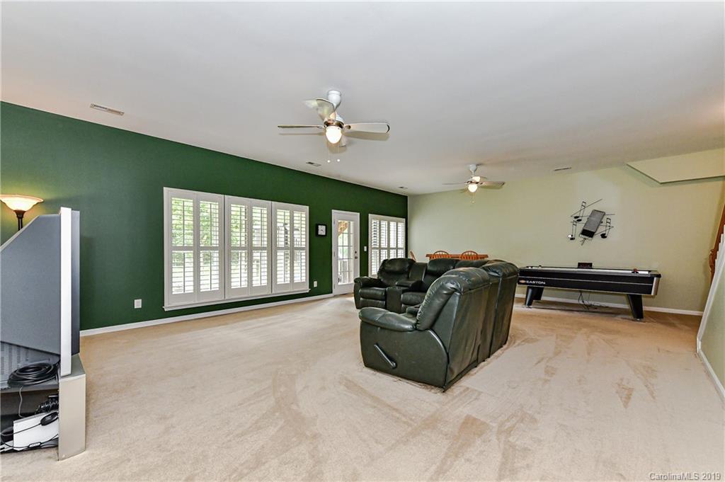 872 Treasure Court Fort Mill, SC 29708 - Photo 33 of 42 a living room with furniture gym equipment and a large window