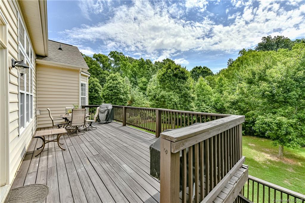 872 Treasure Court Fort Mill, SC 29708 - Photo 37 of 42 a balcony with wooden floor and fence next to a yard